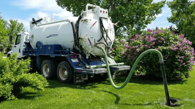 Professional vacuum truck performing residential drainage and septic maintenance in Rockford, IL