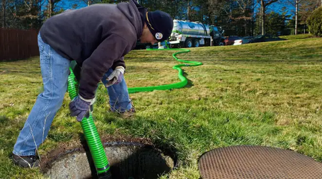Service technician performing residential septic pumping and drainage maintenance in Rockford, IL